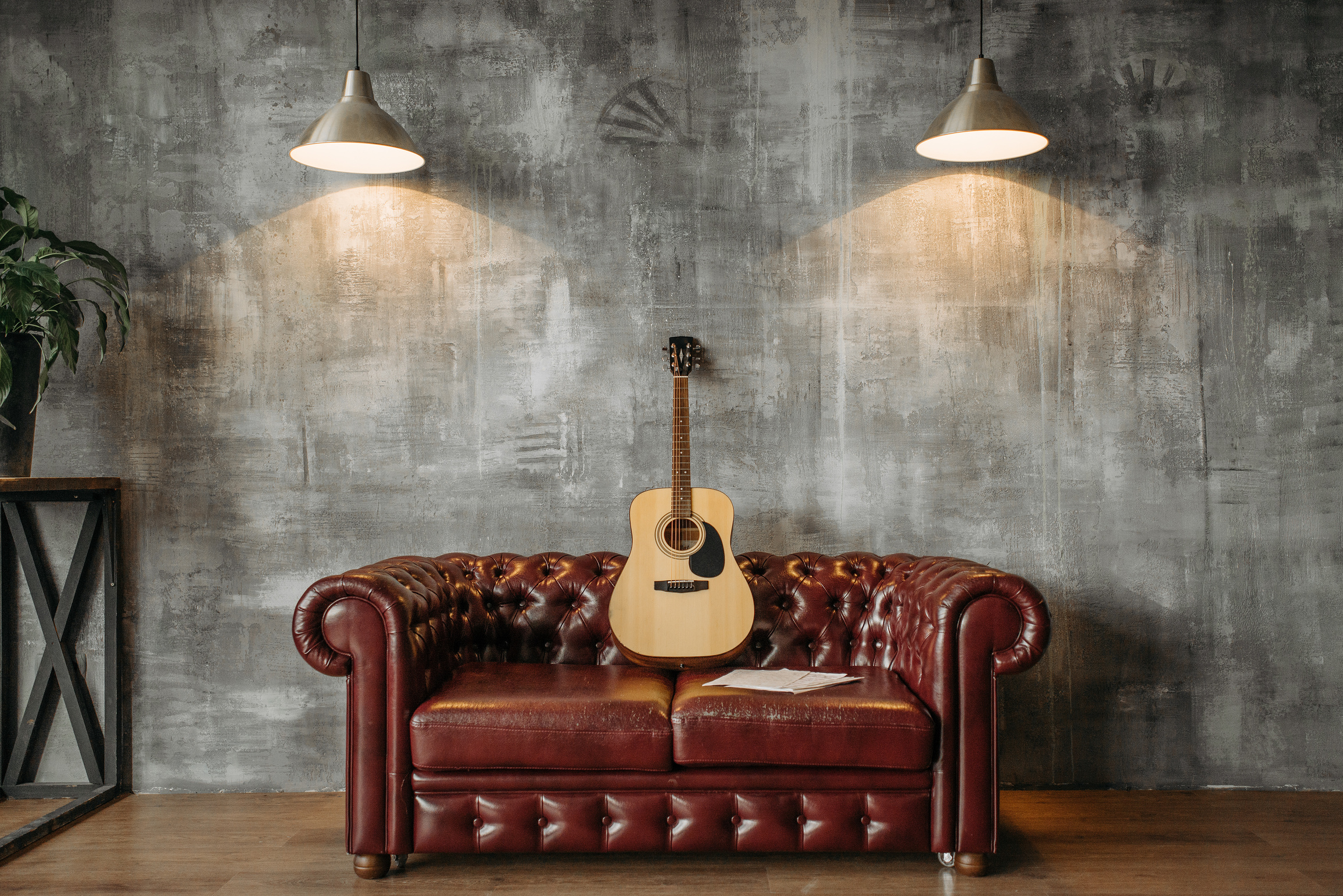 Brown Acoustic Guitar on Leather Sofa 